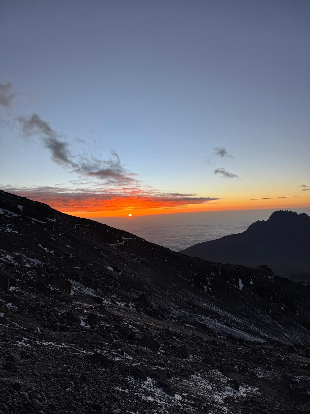 Sunrise from Kilimanjaro summit approach — photo by our founder